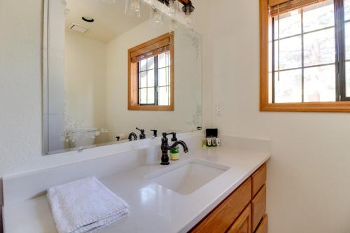 a bathroom with a white sink and a mirror at Lariat House in Sisters