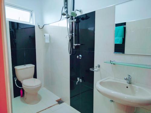 a bathroom with a shower and a toilet and a sink at Mountain View in Kandy