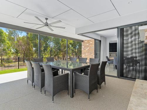 a dining room with a table and chairs at 45 On Fairway in Yarrawonga
