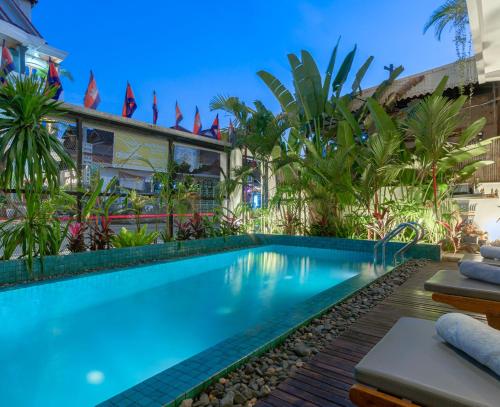 a swimming pool in front of a building at Family Style 3-Bedroom Suite by Baahu Villa in Siem Reap