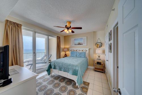 a bedroom with a bed and a ceiling fan at Ocean Villa 1104 in Panama City Beach