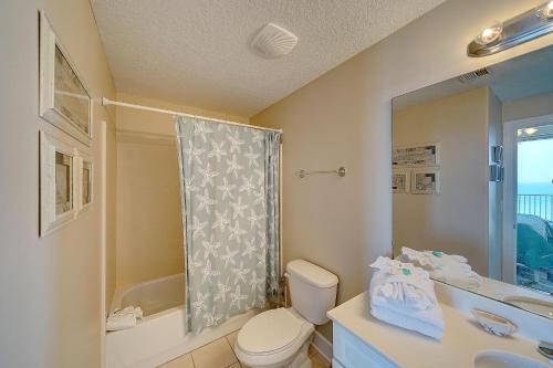 a bathroom with a toilet and a sink and a shower at Ocean Villa 1104 in Panama City Beach