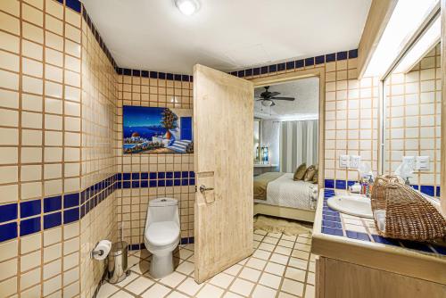 a bathroom with a toilet and a sink at Terrasol Elite Premium Vacation Rentals in Cabo San Lucas