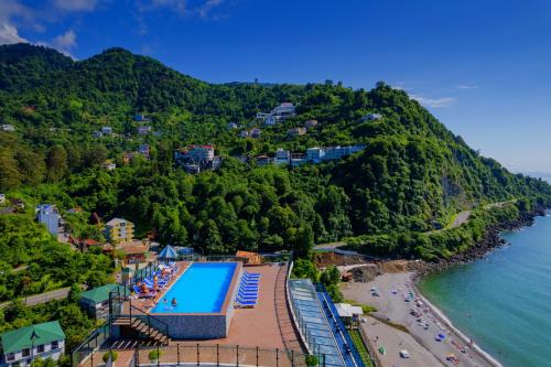 an aerial view of a resort with a swimming pool and a beach at Kvariati Panorama in Kvariati