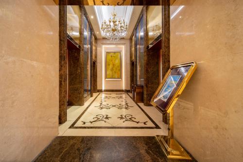 a hallway with a painting on the wall and a mirror at Xingyin Cloudy Hotel Guangzhou Changgang Subway Station - Free Shuttle Bus to Canton Fair Complex During Canton Fair Period in Guangzhou
