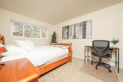 a bedroom with a bed and a desk and a chair at Snowy Peaks Haven in Brian Head