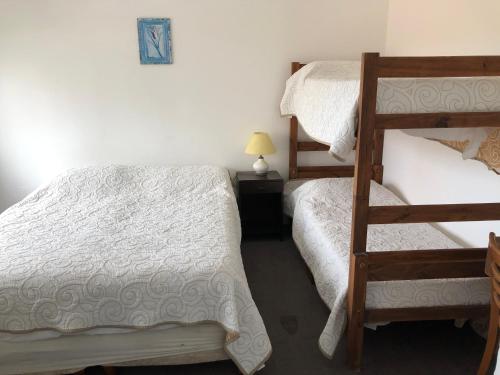 a bedroom with two bunk beds and a ladder at Hotel Gaudí in Punta del Este