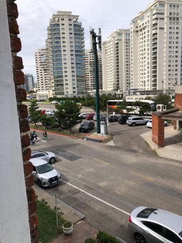 a view of a parking lot with parked cars and buildings at Hotel Gaudí in Punta del Este