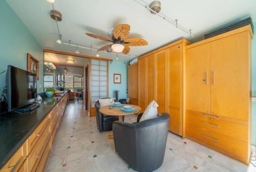 a living room with a couch and a table at Beachfront Condo in Paradise in Waianae