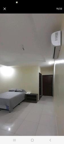 a bedroom with a bed and a room with a door at Espacioso en zona exclusiva in Santa Rosa de Copán