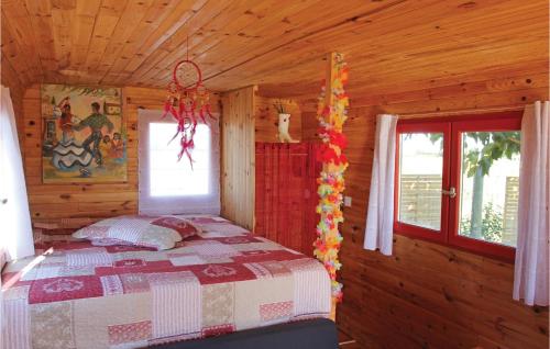 a bedroom with a bed in a wooden cabin at Cozy stacaravan In Franquevaux With Kitchen in Franquevaux
