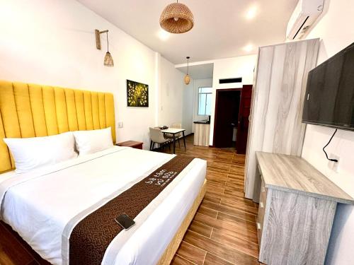 a bedroom with a large bed and a flat screen tv at BA TAM VU SUA Homestay in Ho Chi Minh City