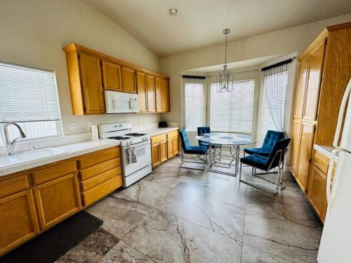 a kitchen with wooden cabinets and a table and chairs at Sweet Holiday in Antelope