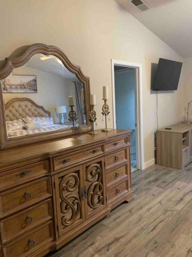 a bedroom with a large wooden dresser with a large mirror at Sweet Holiday in Antelope