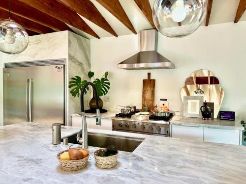 a kitchen with a sink and a counter with fruit at Grand 3 Bedroom Luxury Quiet Private Home Centrally Located in Los Angeles