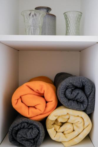 three balls of towels sitting on a shelf at #55highstreetauckland in Auckland