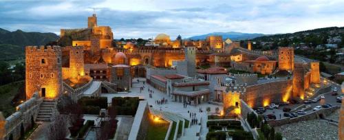 a large building with a castle in a city at My House in Akhaltsikhe in Akhaltsikhe