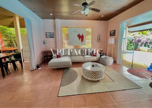 a living room with a couch and a table at Alicia Pool Villa Samui in Mae Nam