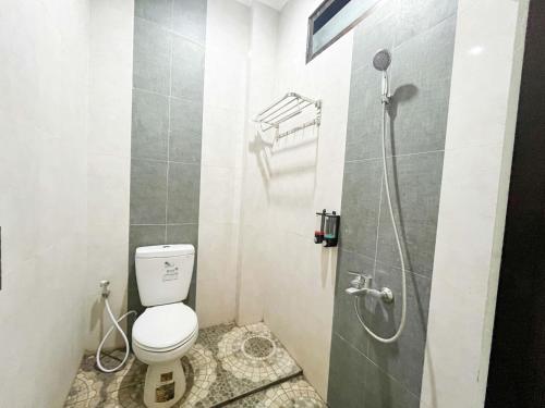 a bathroom with a toilet and a shower at Reddoorz Near BNS 2 in Tlekung
