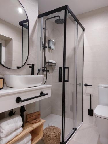 a bathroom with a sink and a shower at Pensión Cabezas Oviedo in Oviedo