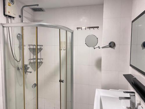 a bathroom with a shower and a sink at The Freelancer Hotel in Pattaya Central