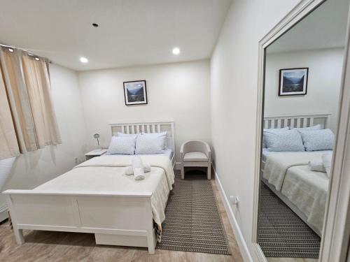 a bedroom with two beds and a mirror at 1-Bedroom Apt-9W1 20-Minuite To Downtown Boston in Boston