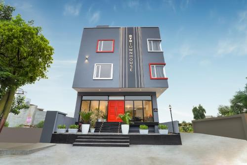 a rendering of a house with a red door at Super Townhouse Golden Avenue Road in Amritsar