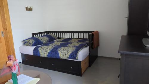 a bedroom with a bed with blue comforter and pillows at Bydlení v centru OV blízko Stodolní, bez výtahu in Moravská Ostrava