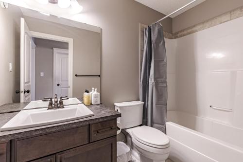a bathroom with a sink and a toilet and a shower at Lux-Rooms in Allard Edmonton in Edmonton