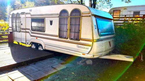 an old rv parked next to a wooden ramp at Wathne Camping in Bjørheimsbygda
