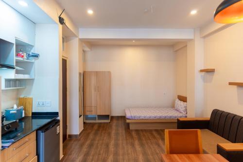 a small room with a couch and a bed at POKHARA APARTMENTS INN in Pokhara