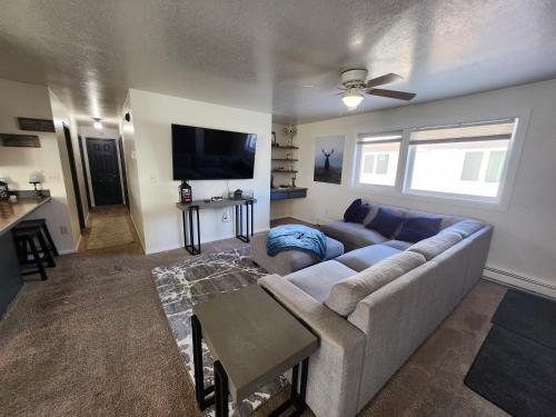 a living room with a couch and a tv at Newly furnished relaxing stay in Fairbanks