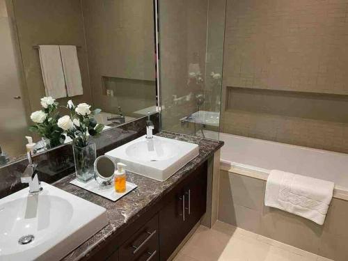a bathroom with two sinks and a large mirror at Three bedroom apartment in Saadiyat district in Abu Dhabi
