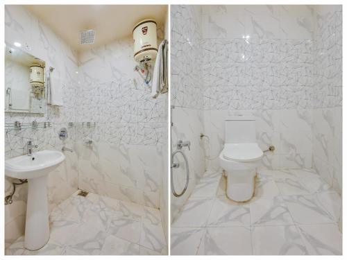 a white bathroom with a toilet and a sink at Hotel Ludhiana Regency in Ludhiana