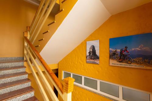 a staircase in a house with yellow walls at POKHARA APARTMENTS INN in Pokhara