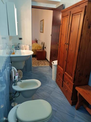 a bathroom with a toilet and a sink at Casa Bonaria - IUN R 6698 in SantʼAntìoco