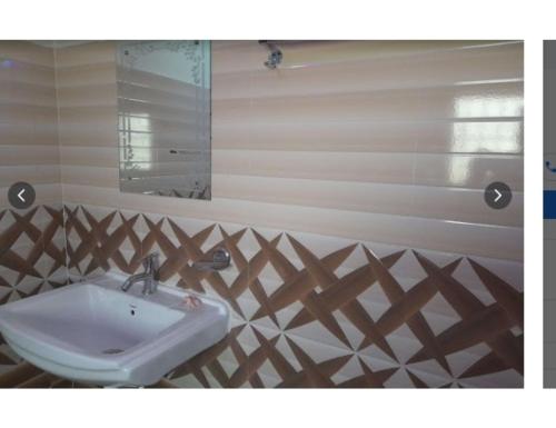 a bathroom with a sink and a mirror at Similipal Eco Retreat, Jaybilla, Odisha in Bālidiha