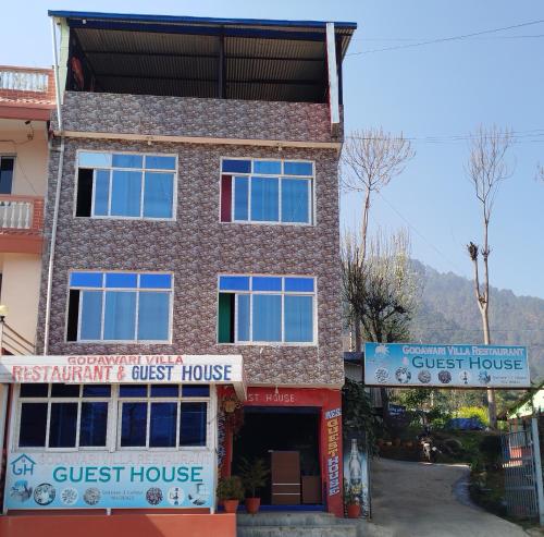 a guest house in front of a building at Godawari villa guest house in Godāvari