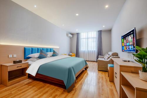 a bedroom with a large bed and a couch at Mando Hotel - Kunming Changshui International Airport in Kunming