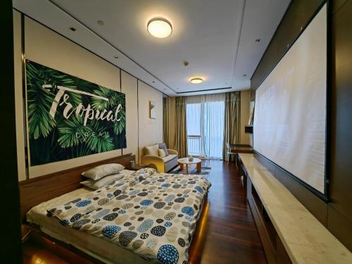 a hotel room with a large projection screen and a bed at 邻致公寓东站中汇店 in Guangzhou