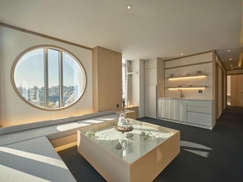 a bathroom with a large window and a tub at UH Suite The Seoul in Seoul