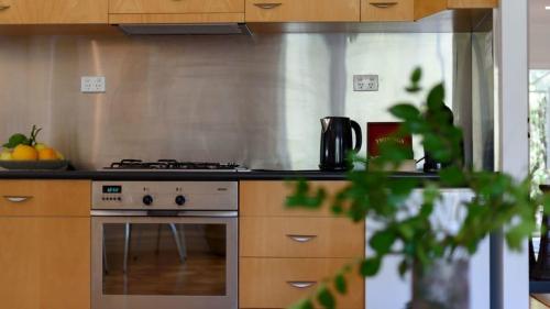 a kitchen with a stove and a counter top at Lakeside Suite 2 - Lake View & Spa Bath in Daylesford