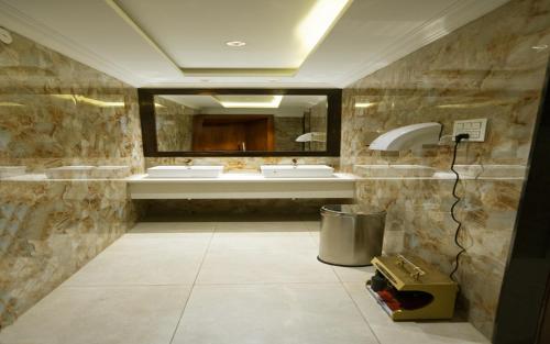 a bathroom with two sinks and a mirror at NAR Comforts in Bangalore