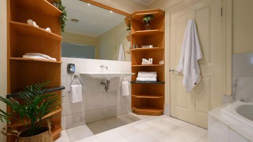 a bathroom with a sink and a toilet and a tub at Lakeside Suite 1 - Lake View & Spa Bath in Daylesford