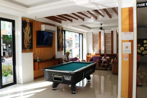 a living room with a pool table in it at Diamond Crown in Patong Beach