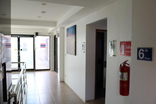 a hallway with a fire hydrant on the wall at Diamond Crown in Patong Beach