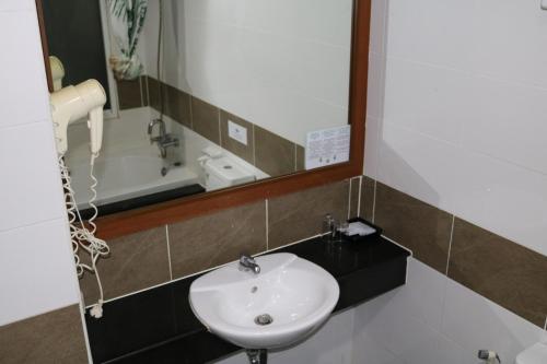 a bathroom with a sink and a mirror at Diamond Crown in Patong Beach