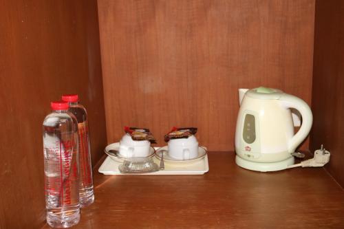 a bottle of water and a tea kettle on a table at Diamond Crown in Patong Beach