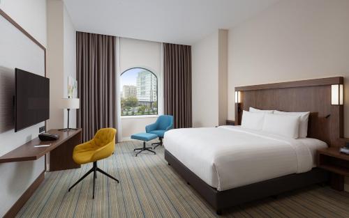 a hotel room with a bed and a window at Courtyard by Marriott Baku in Baku