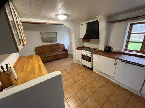 a kitchen with a wooden table and a counter top at korsholt-natur 135E in Sindal